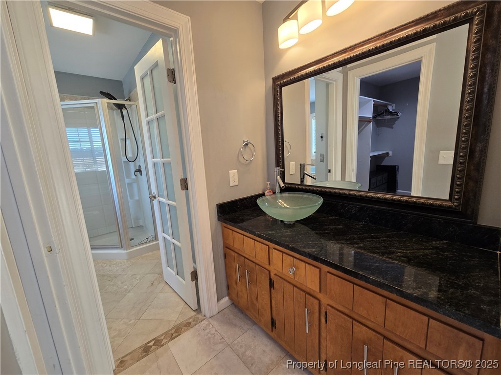 692 Cedar Point Vass, NC 28394 - Photo 38 of 46 a bathroom with a granite countertop sink and a mirror