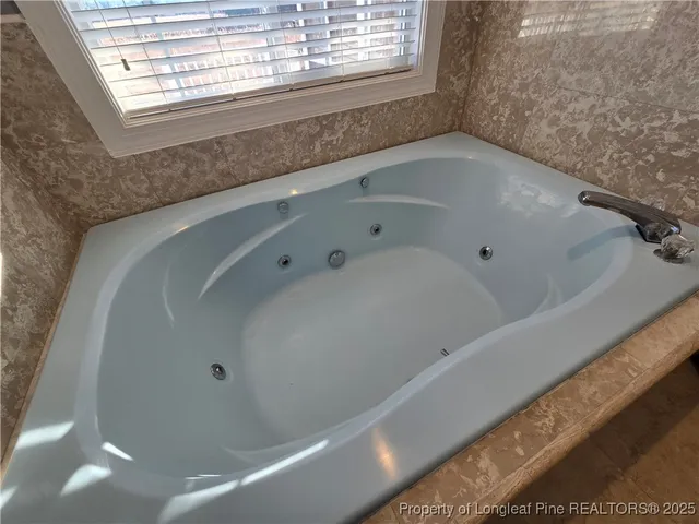 a bathroom with a glass shower door and a mirror