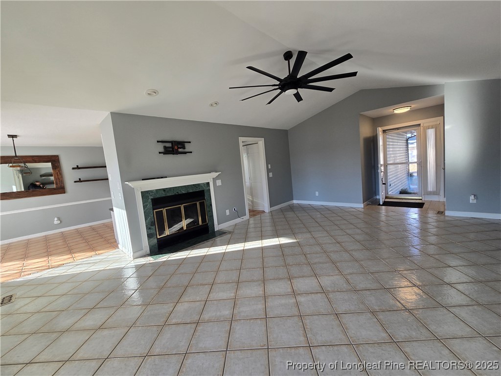 692 Cedar Point Vass, NC 28394 - Photo 46 of 46 a view of a livingroom with a fireplace a ceiling fan and windows