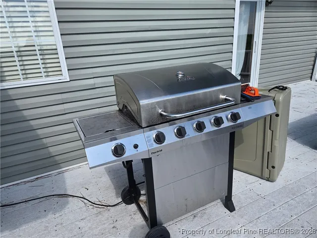 a view of barbeque grill with wooden fence