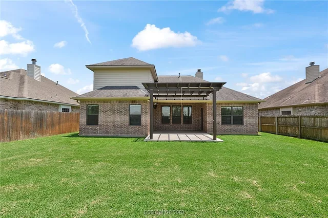a view of a house with a yard and sitting area
