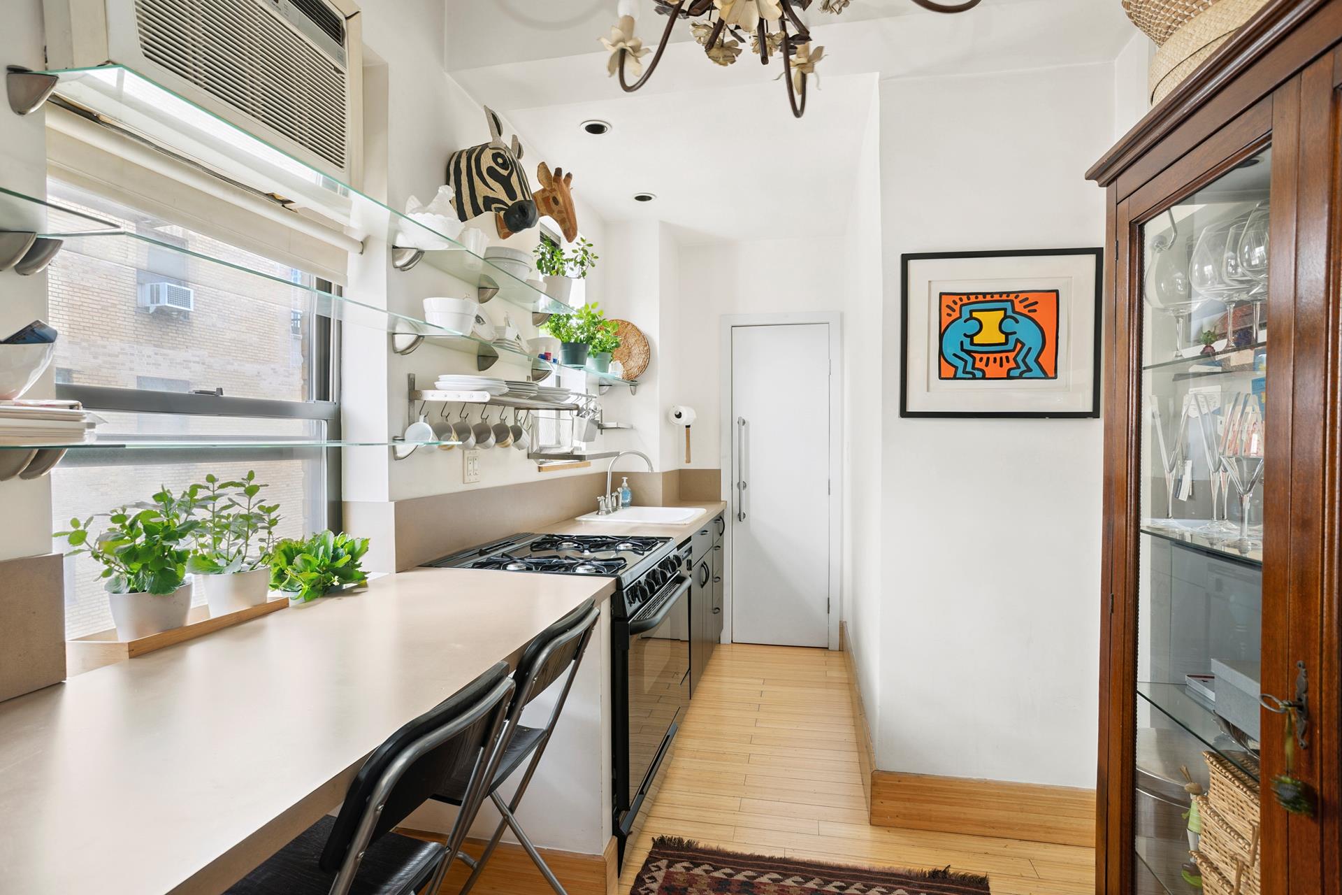 269 West 72nd Street, Unit 16D Manhattan, NY 10023 - Photo 3 of 7 a view of a dining room with furniture a potted plant and wooden floor