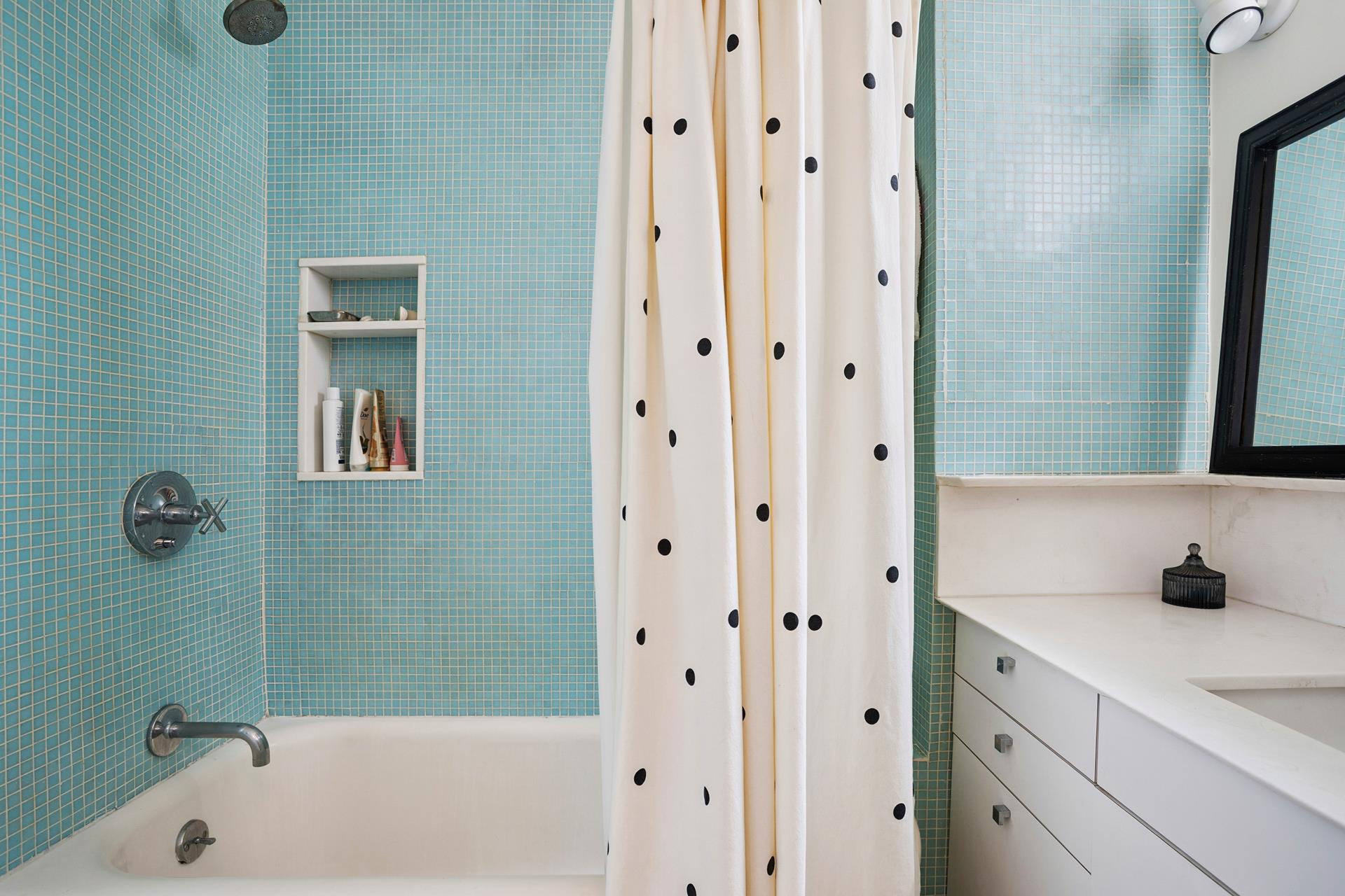 269 West 72nd Street, Unit 16D Manhattan, NY 10023 - Photo 5 of 7 a bathroom with a tub shower and sink