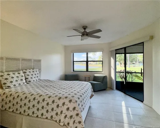 a bedroom with a bed couches and window