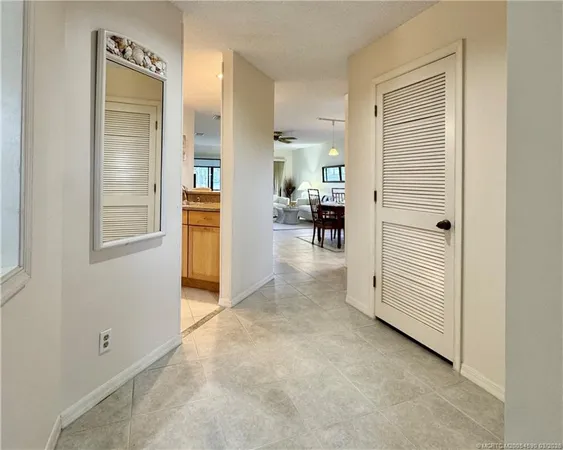 a view of a livingroom with furniture and an entrance to other room