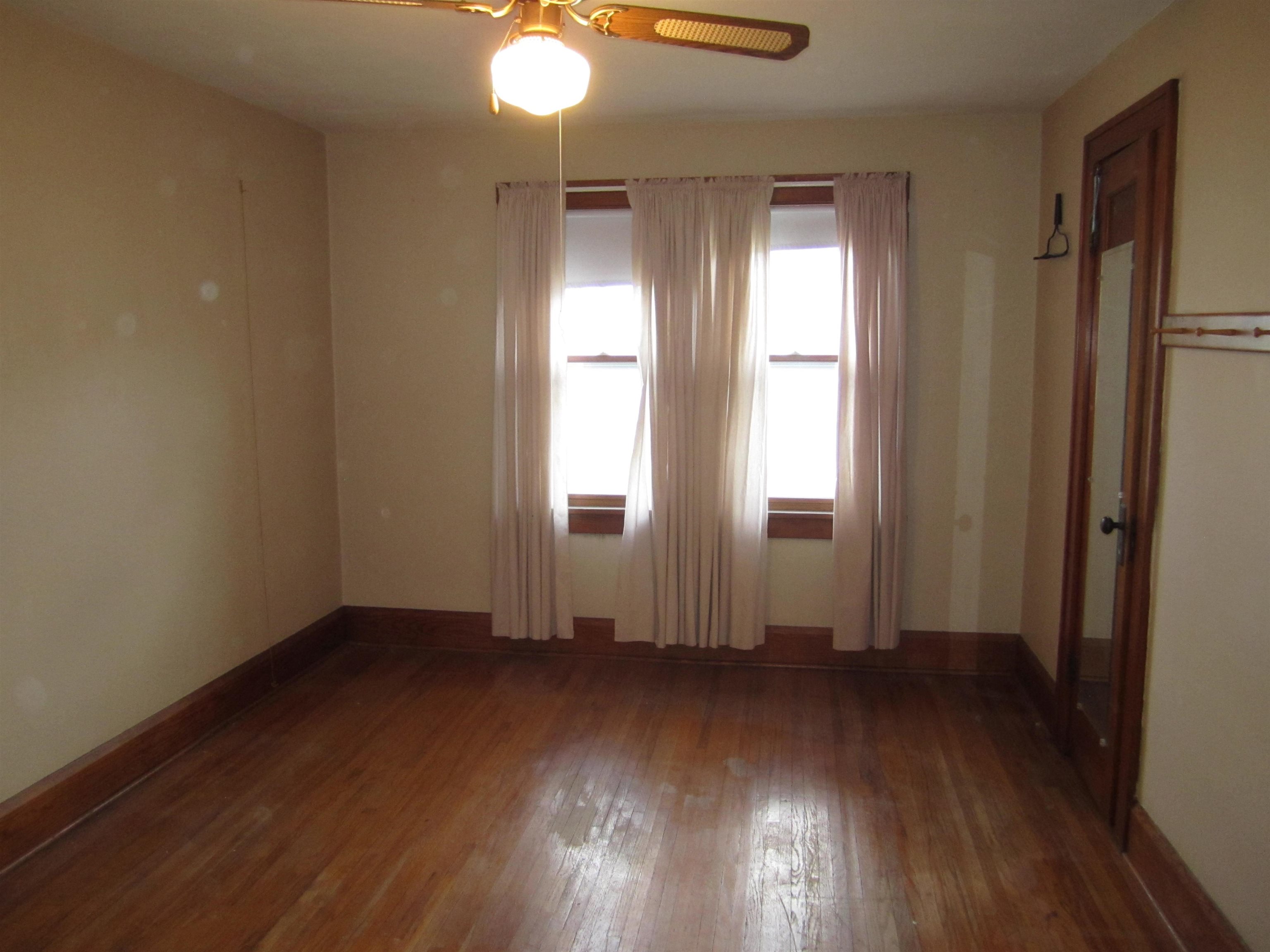 1107 South Main Street Belvidere, IL 61008 - Photo 13 of 21 an empty room with wooden floor and windows