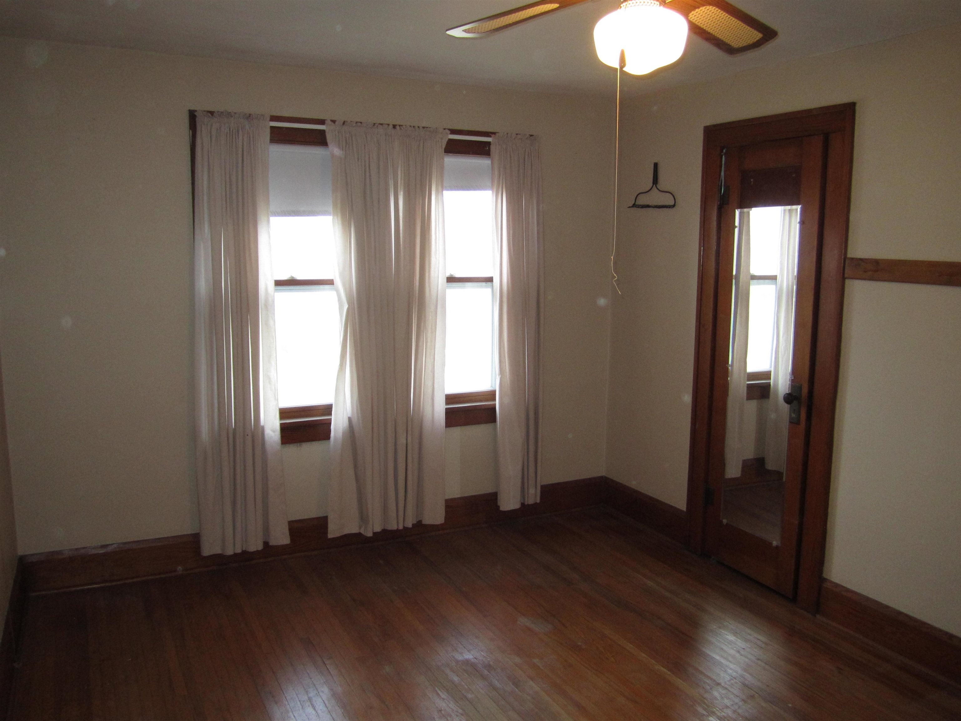 1107 South Main Street Belvidere, IL 61008 - Photo 14 of 21 an empty room with wooden floor and windows