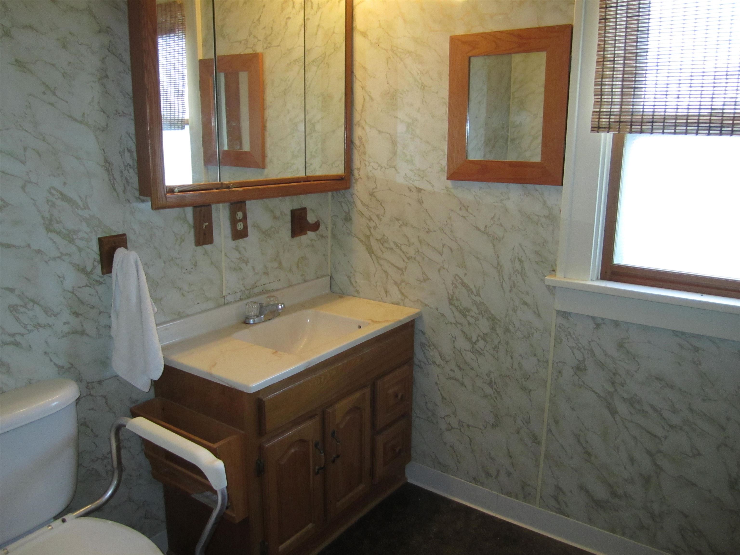 1107 South Main Street Belvidere, IL 61008 - Photo 15 of 21 a bathroom with a sink and a toilet