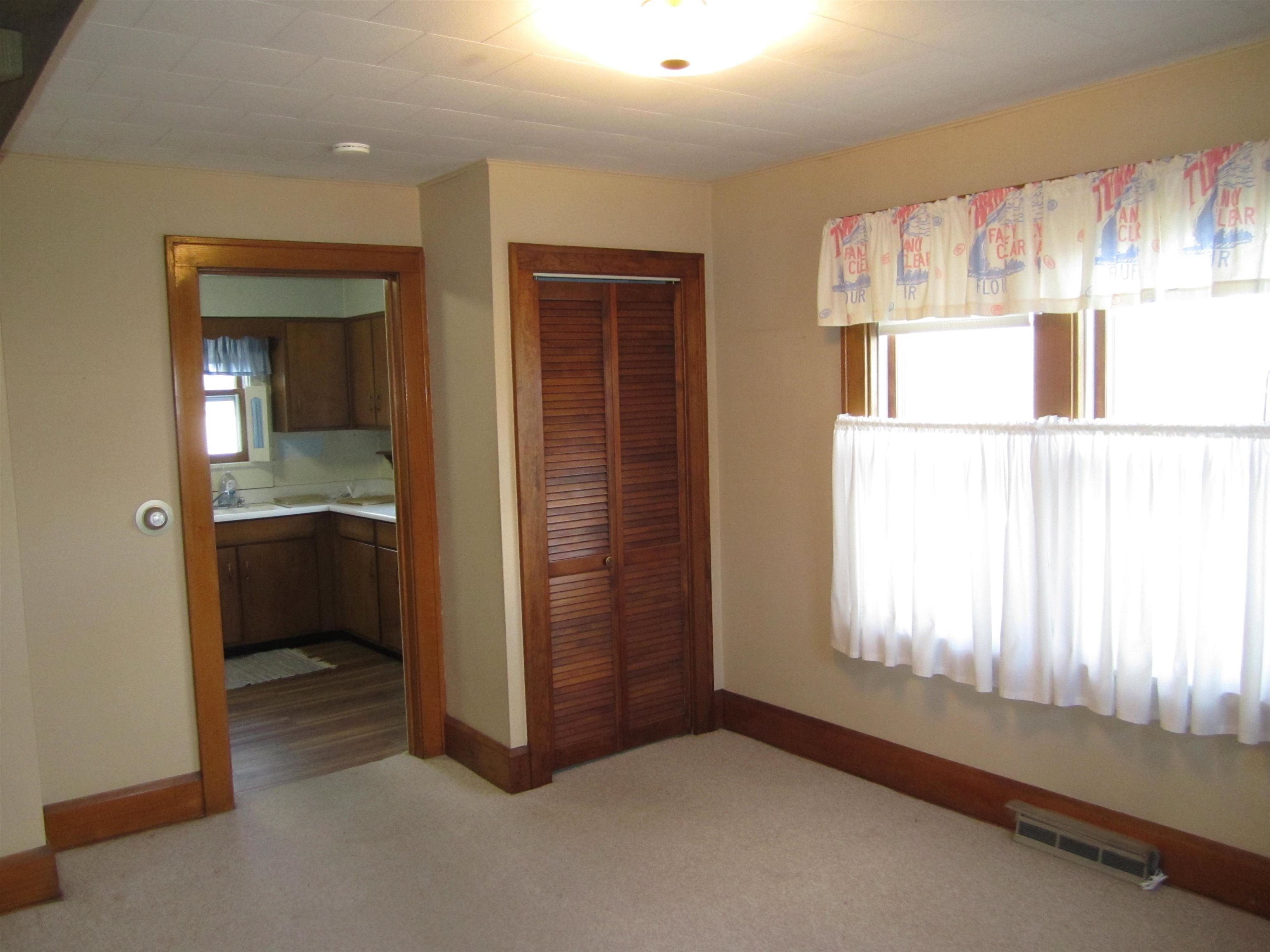 1107 South Main Street Belvidere, IL 61008 - Photo 6 of 21 a view of an empty room with a kitchen