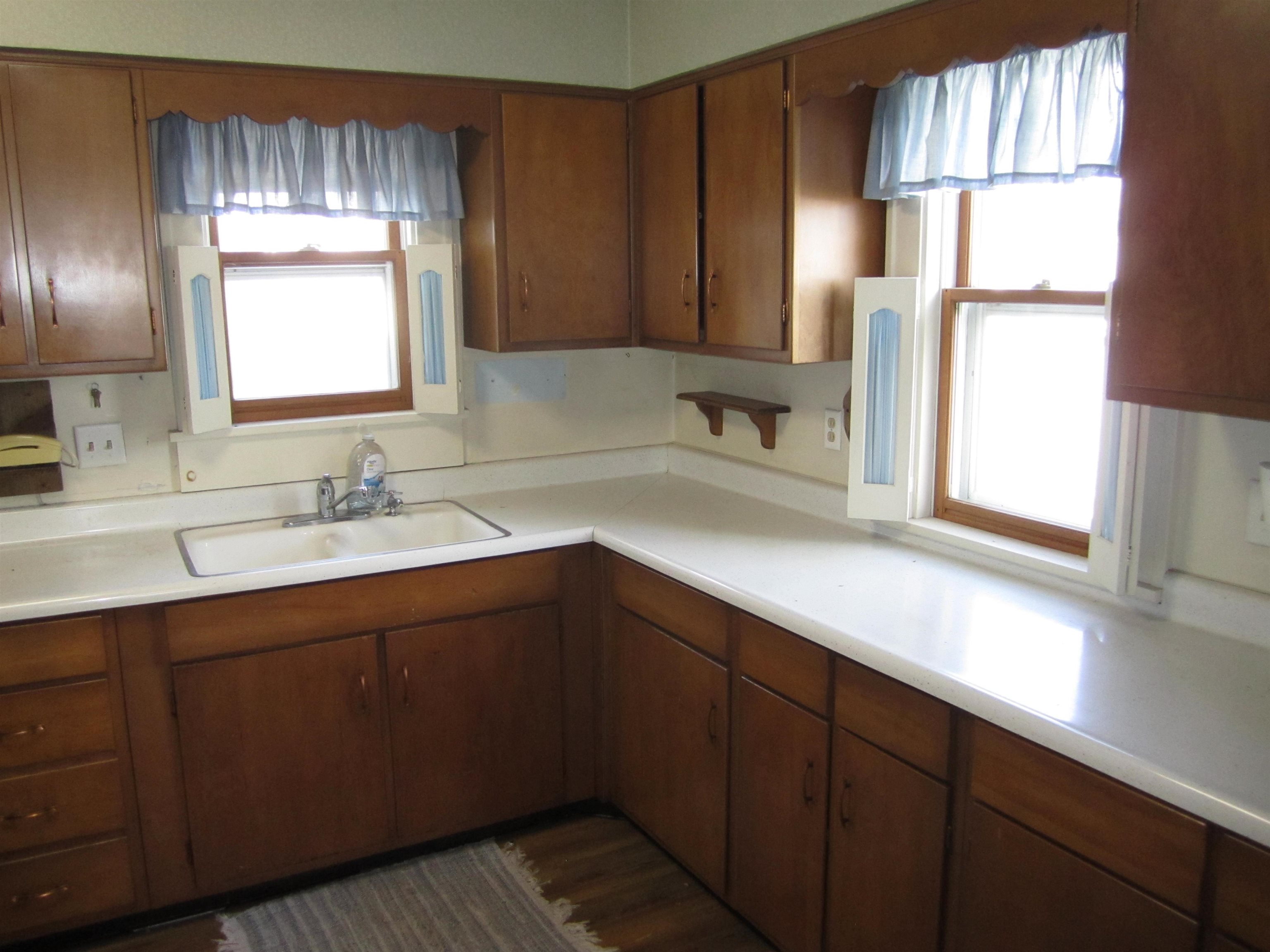 1107 South Main Street Belvidere, IL 61008 - Photo 9 of 21 a kitchen with a sink window and cabinets