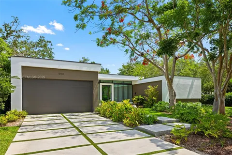 a kitchen with stainless steel appliances granite countertop a sink a refrigerator and chairs