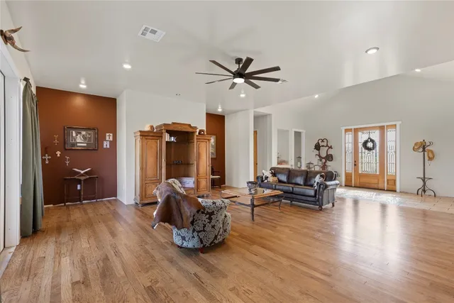 a living room with furniture and a view of kitchen