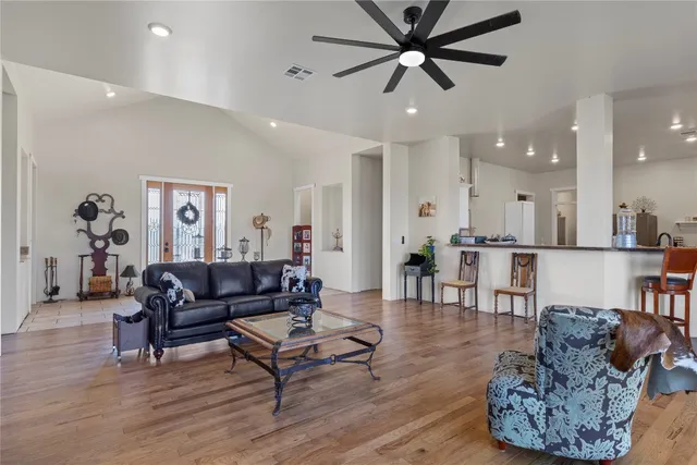 a dining room with furniture and wooden floor