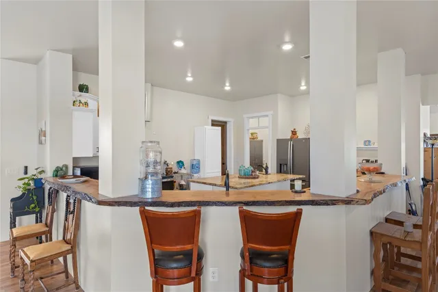 a kitchen with stainless steel appliances granite countertop sink stove and white cabinets