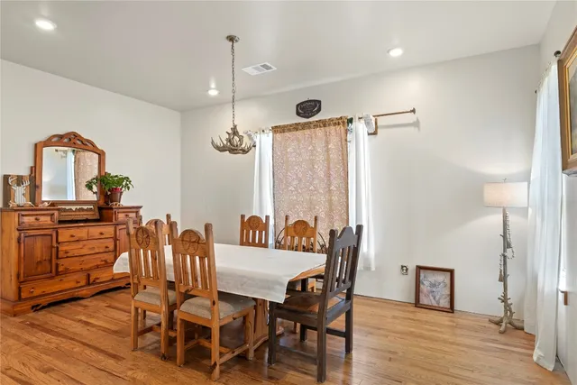 a view of a a dining room with furniture window and wooden floor