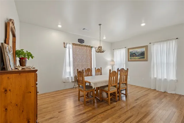 a spacious bedroom with a large bed and a chandelier