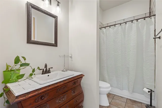 a bedroom with a bed a window and a rug