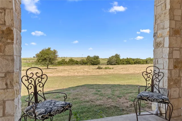 a living room with furniture and floor to ceiling windows