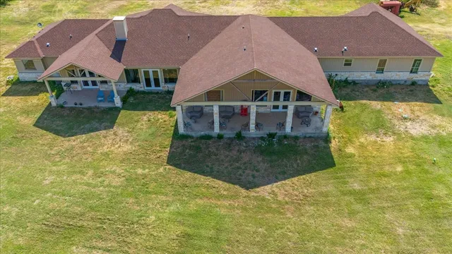 a view of a house with a yard and ocean view