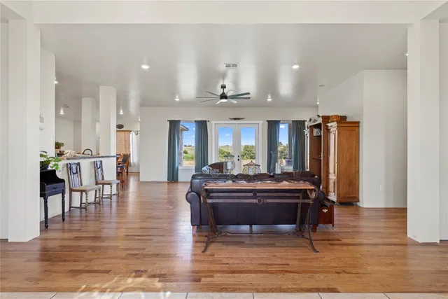 a view of a large kitchen with furniture and wooden floor