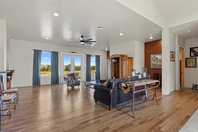 a living room with furniture and wooden floor