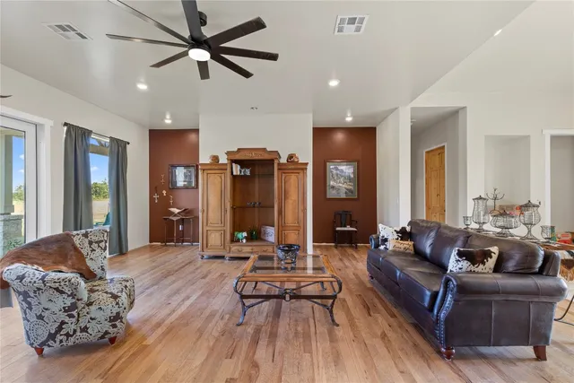 a living room with furniture and wooden floor