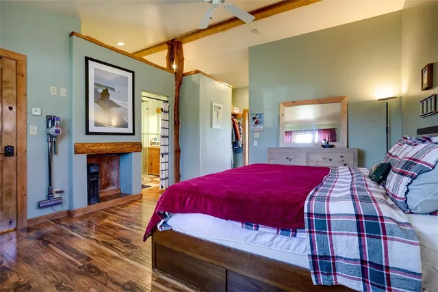 a bedroom with a bed and a mirror on dresser