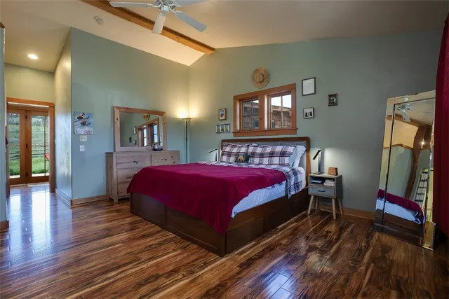 a bed sitting in a bedroom next to a window with a dresser