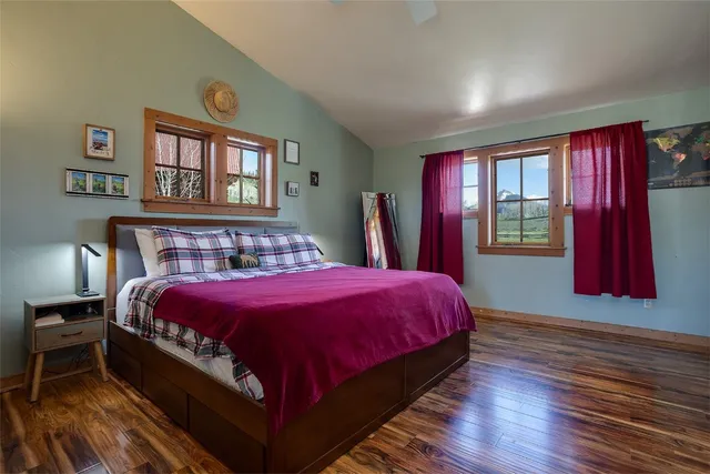 a large bed sitting in a bedroom next to a window