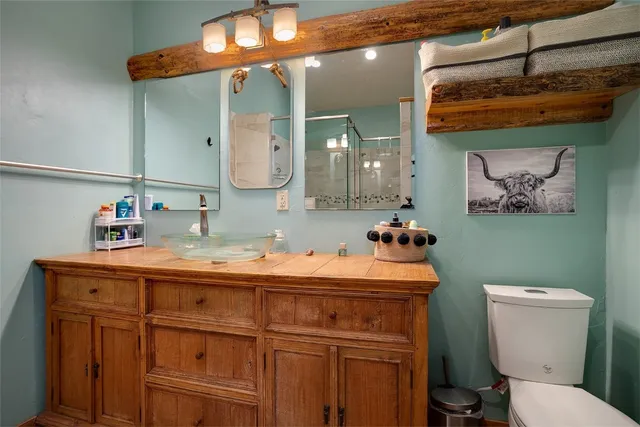 a bathroom with a toilet a sink and mirror