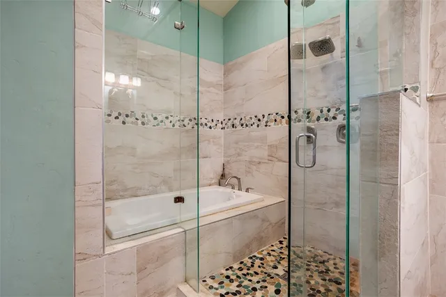 a bathroom with a bathtub and a shower