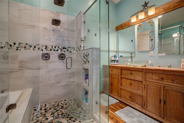 a bathroom with a double vanity sink a mirror and shower