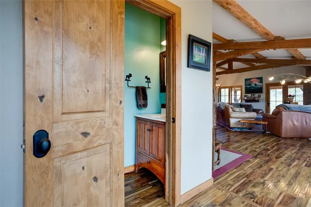a view of hallway with wooden floor