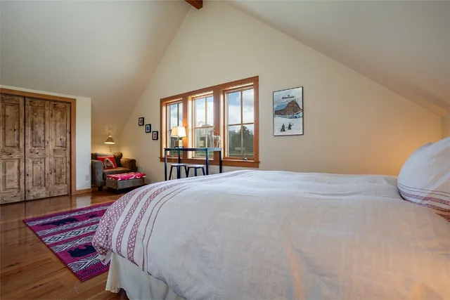 a bedroom with furniture and a window