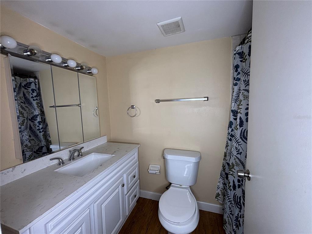 800 North Fiske Boulevard, Unit 815 Cocoa, FL 32922 - Photo 11 of 14 a bathroom with a sink a toilet a mirror and vanity