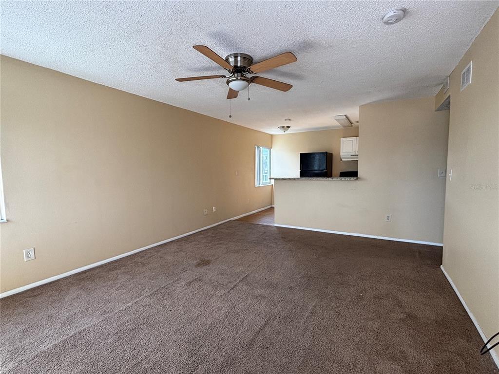 800 North Fiske Boulevard, Unit 815 Cocoa, FL 32922 - Photo 6 of 14 a view of a livingroom with a ceiling fan and a window