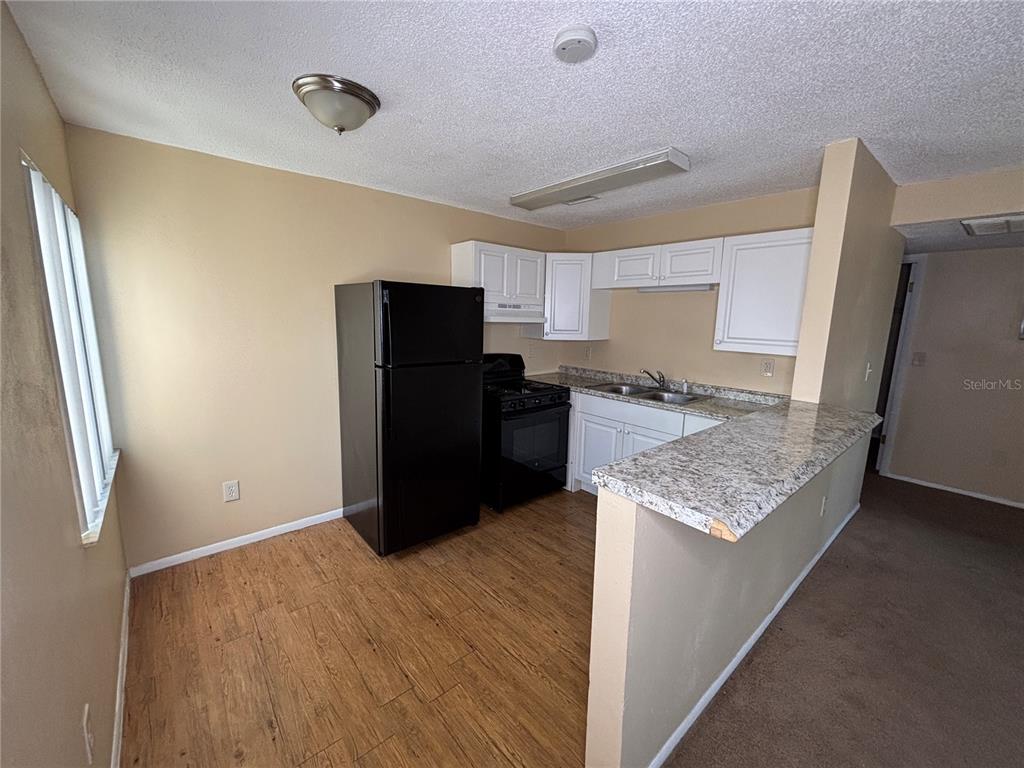 800 North Fiske Boulevard, Unit 815 Cocoa, FL 32922 - Photo 8 of 14 a kitchen with granite countertop a refrigerator and a sink