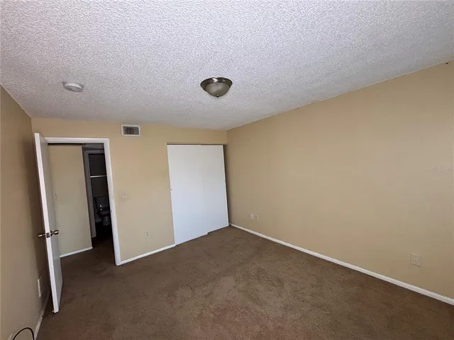 an empty room with windows and entrance