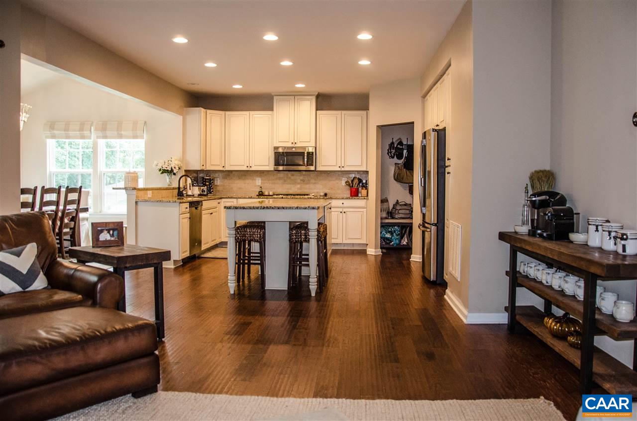 292 Ridgemont Road Ruckersville, VA 22968 - Photo 1 of 50 a open kitchen with stainless steel appliances granite countertop a stove top oven a refrigerator a dining table and chairs with wooden floor