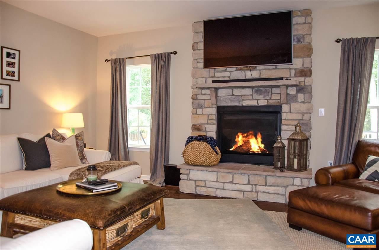 292 Ridgemont Road Ruckersville, VA 22968 - Photo 12 of 50 a living room with furniture a flat screen tv and a fireplace