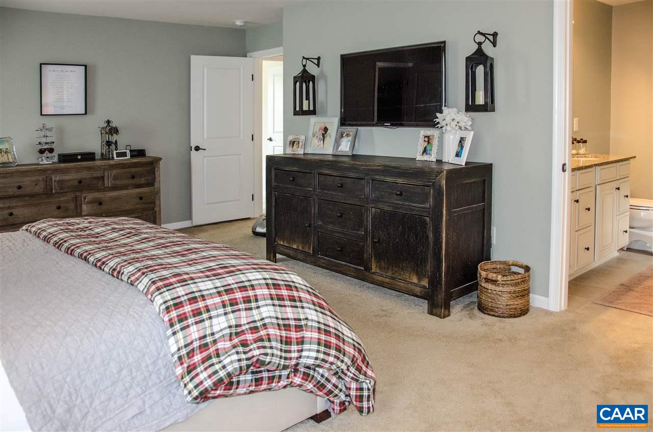 292 Ridgemont Road Ruckersville, VA 22968 - Photo 21 of 50 a bedroom with a bed and a flat screen television