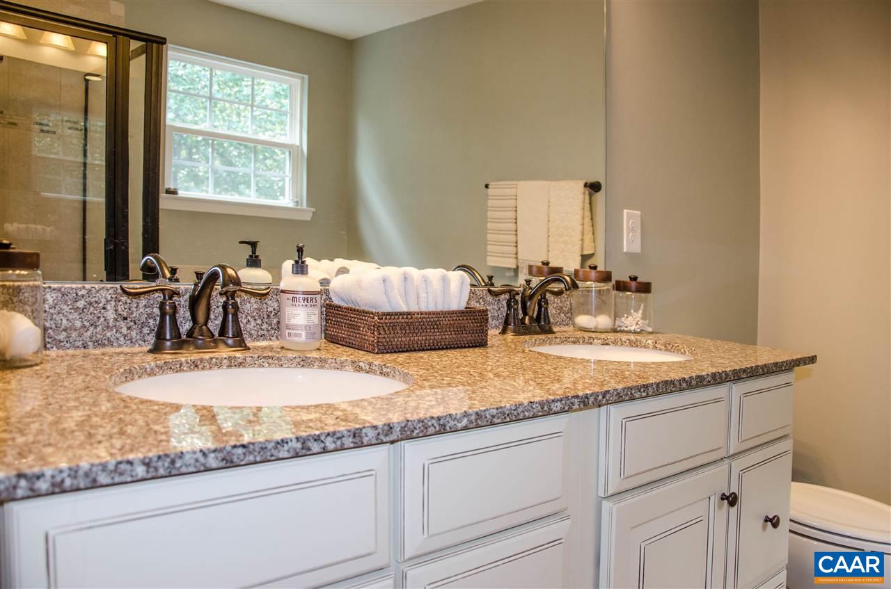 292 Ridgemont Road Ruckersville, VA 22968 - Photo 26 of 50 a bathroom with a granite countertop sink and a mirror
