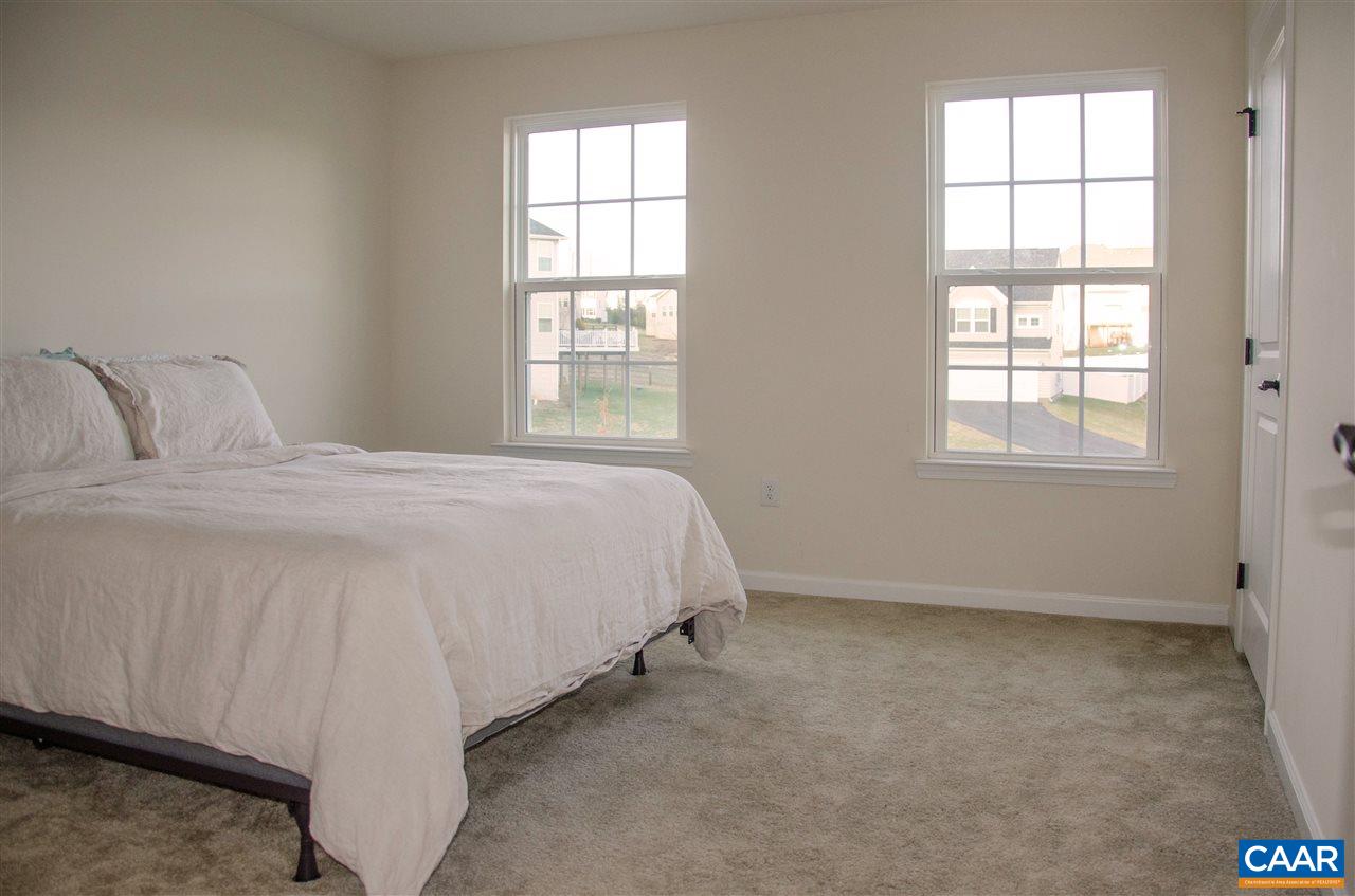 292 Ridgemont Road Ruckersville, VA 22968 - Photo 31 of 50 a spacious bedroom with a bed and a window