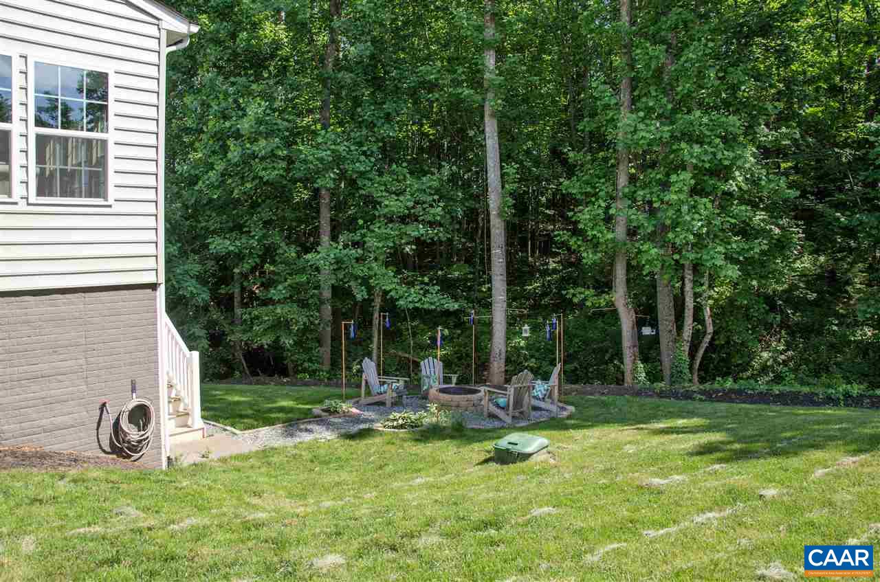 292 Ridgemont Road Ruckersville, VA 22968 - Photo 42 of 50 a view of a bench in the garden of a house
