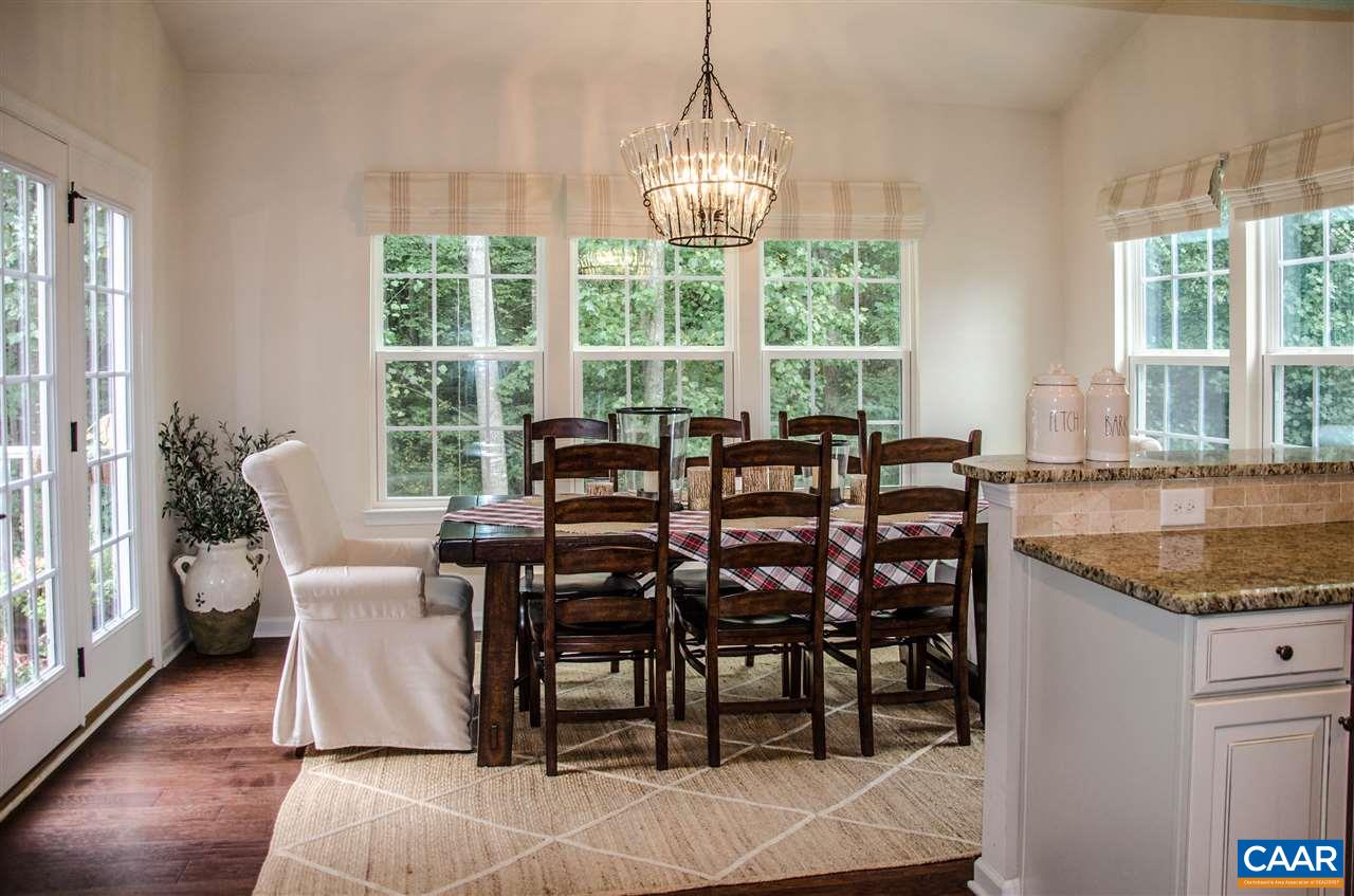 292 Ridgemont Road Ruckersville, VA 22968 - Photo 7 of 50 a dining room with furniture a chandelier and wooden floor