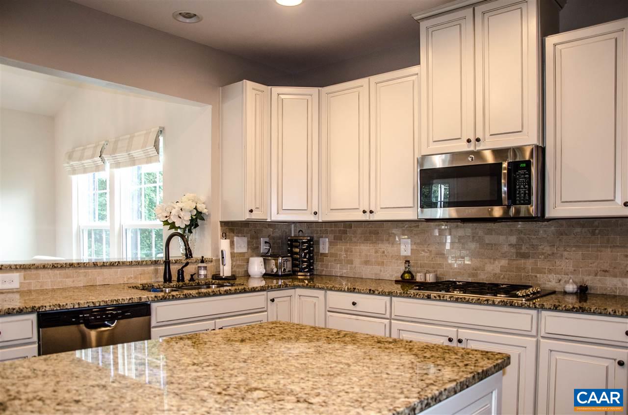 292 Ridgemont Road Ruckersville, VA 22968 - Photo 9 of 50 a kitchen with stainless steel appliances granite countertop a stove a sink and a microwave