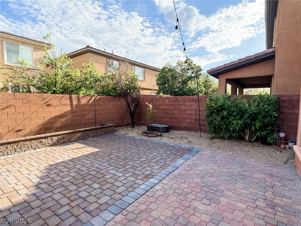 8683 Moreno Mountain Avenue Las Vegas, NV 89178 - Photo 25 of 26 An inviting backyard features durable pavers and a low-maintenance landscape design, perfect for outdoor enjoyment.