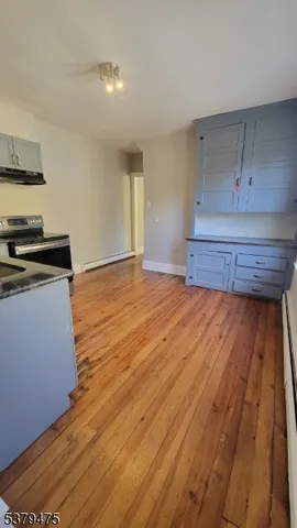 a kitchen with wooden floors and appliances