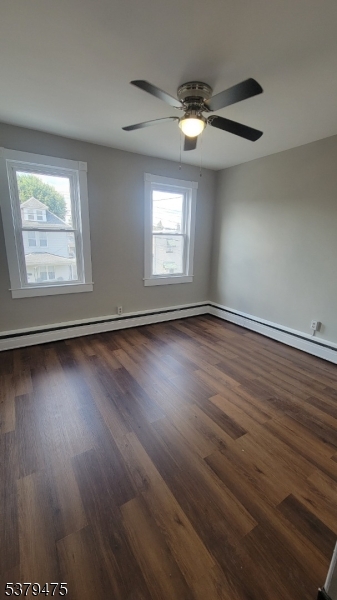 244 Irwin Street Phillipsburg, NJ 08865 - Photo 9 of 15 an empty room with wooden floor fan and windows