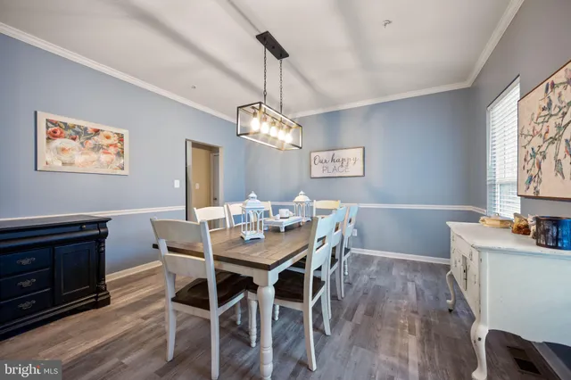 a kitchen with stainless steel appliances kitchen island granite countertop a sink counter and chairs